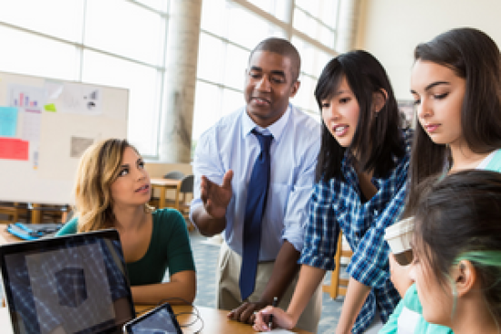 Group of students working together in front of a computer